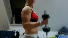 Muscle Girl Doing Some Bicep Curls And Posing